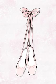 a pair of ballet shoes tied together with a pink ribbon on top of the shoe