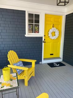 a yellow chair sitting on top of a wooden floor next to a yellow front door