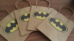 four brown paper bags with batman stickers on them