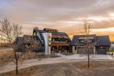 a large house sitting on top of a dirt field