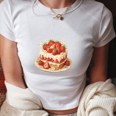 Indulge your sweet side with our delightful Women's Baby Tee Crop Top featuring a scrumptious strawberry cake graphic! Embrace the Y2K aesthetic with this trendy piece that adds a pop of sweetness to your wardrobe. Perfect for the coquette in you, this cute crop top is a must-have for baking enthusiasts and lovers of all things adorable. Whether you're rocking it as part of a cottagecore ensemble or simply adding a touch of whimsy to your everyday style, this Strawberry Cake Baby Tee is sure to Sweet White Tops With Strawberry Print, Sweet White Tops For Birthday, Sweet White Top For Birthday, Cute Strawberry Print Top For Birthday, Baby Tee Aesthetic, Cake Graphic, Aesthetic Strawberry, Coquette Clothing, Clothing Y2k