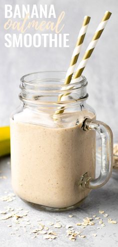 a banana and oatmeal smoothie in a mason jar with two straws