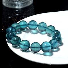 FREE SHIPPING on all items! Experience the exquisite beauty and rarity of our Natural Brazilian Old Mine Devil Blue and Green Aquamarine Round Bead Bracelet. This stunning piece, known for its exceptional quality and vibrant hues, is a true collector's item. Product Details: Material: Genuine Aquamarine Colors: Devil Blue and Green Bead Shape: Round Grade: Collector's Grade Bracelet Type: Stretchable Bead Bracelet Features: Unique Color: The captivating devil blue and green hues are highly sought after and rare, making this bracelet a unique addition to any jewelry collection. High Quality: Sourced from old mines in Brazil, these beads are of the finest quality, ensuring durability and long-lasting beauty. Versatile Design: The round bead design and stretchable band make this bracelet comf Blue Polished Beads Round Bracelet, Blue Polished Beads Bracelet, Blue Gemstone Beads Bangle Bracelet, Blue Polished Beads Round Bracelets, Blue Polished Beads Bracelets, Blue Bangle Bracelets With Gemstone Beads, Handmade Sapphire Color Bracelets With Round Beads, Sapphire Gemstone Beads Bracelets, Green Aquamarine