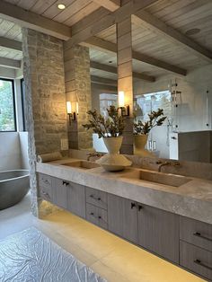 a bathroom with two sinks and a large mirror in it's center area, next to a bathtub