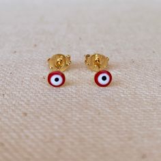 A dainty minimalist 18k Gold Filled evil eye stud earrings featuring red colored enamel finish. Metal: 18k Gold Filled Dimension: 2.5mm stud Weight 0.4 grams/ pair Hypoallergenic and waterproof jewelry Handcrafted in Brazil Learn how to care for your jewelry with these easy instructions. Properly handling and caring for your ArtBossa jewelry is essential in maintaining its pristine condition. 1. Keep your gold-filled jewelry away from chemicals and cleaning products. Remove your jewelry when han Dainty Red Earrings For Everyday, Red Hypoallergenic Dainty Earrings, Hypoallergenic 14k Gold Red Jewelry, Dainty Red 14k Gold Earrings, Red Evil Eye, Horn Pendant, Waterproof Jewelry, Birthstone Charms, Gold Filled Jewelry