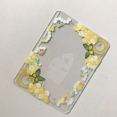 a clear case with yellow and white flowers on it