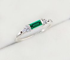 925 Sterling Silver Fashion Jewelry Beautiful Created Emerald & CZ Diamond Ring, This Ring is perfect gift for special love one. Emerald is a very popular gemstone in Today's Fashion. M A T E R I A L S: * 925 Sterling Silver * Lab Created Emerald * Main Stone Baguette 5x2.5 mm * Accented with tiny Cubic Zircon * Comes in our beautiful handmade gift box This simple and cute Baguette Emerald Ring. Amazingly young look for daily casual wear. Beautifully craft handmade silver ring. Occasion:  Party, Dainty Sterling Silver Emerald Ring With Bezel Setting, Sterling Silver Stackable Rings For Anniversary - May Birthstone, White Gold Sterling Silver Stackable Rings For May Birthstone, Sterling Silver Stackable Rings For Anniversary, May Birthstone, White Gold Sterling Silver Emerald Ring With Bezel Setting, Fine Jewelry Sterling Silver Stackable May Birthstone Rings, Dainty Silver Emerald Ring For Anniversary, Sterling Silver Stackable Emerald Ring As Gift, Emerald Cut Sterling Silver Stackable Promise Rings