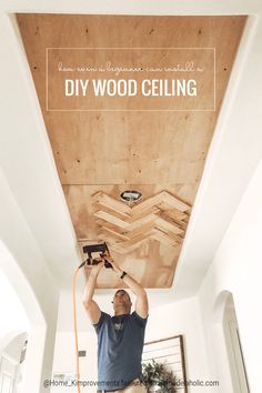 a man is working on the ceiling in his home