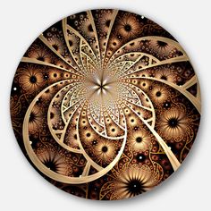 an intricate golden and black design on a round clock