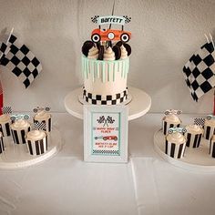 a birthday cake and cupcakes are on display at a race car themed party