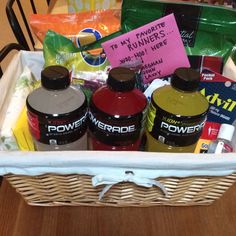 a basket filled with lots of food and condiments on top of a table