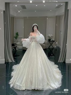 a woman in a white wedding dress is posing for the camera