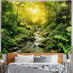 a bedroom with a bed and wall mural depicting a forest stream in the sunbeams