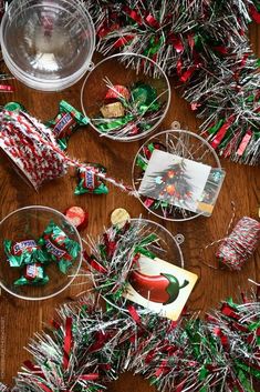 christmas candies and candy are on the table next to other holiday decorations, including tinsel