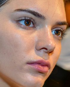 a close up of a woman with blue eyes