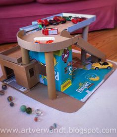 a table made out of cardboard with cars on it