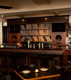 an empty bar with lots of bookshelves in the back ground and tables on either side