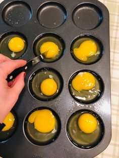 an egg being cooked in a muffin tin