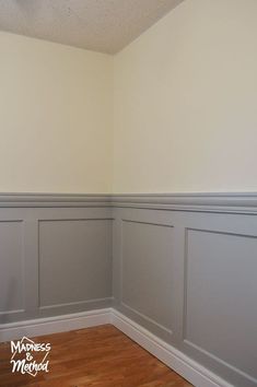 empty room with white walls and wood flooring in the corner, painted light gray