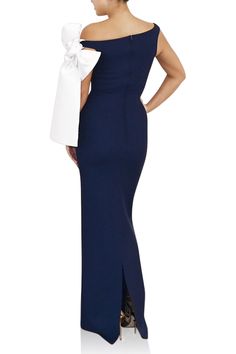 Greta Constantine Calandra Dress. This Navy, floor length, asymmetrical neckline gown with a playful knot in contrasting White. Pure elegance!Email info@wdrobeapparel.com for more information or different color options. True to size 68% Polyamide | 32% Elastane Made in Toronto | Fabric milled in Italy *Note that made-to-order pieces take 22 - 26 weeks to ship. Chic Floor-length Evening Dress With Bow, Chic Bow Floor-length Evening Dress, Evening Maxi Dress With Bow, White Gown With Asymmetrical Neckline For Gala, Sleeveless Bow Maxi Dress For Evening, Bow Detail Maxi Length Dress, White Maxi Dress With Asymmetrical Neckline For Evening, White One Shoulder Maxi Dress For Formal Events, White One Shoulder Maxi Dress For Formal Occasions