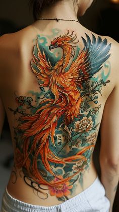 Intricate and colorful phoenix rising tattoo design on back with flowers and ornamental elements Phoenix Lower Back Tattoo Women, Fanfiction Tattoo, Tattoo Back Design, Colorful Phoenix Tattoo, Phoenix Reference, Phoenix Rising Tattoo, Phoenix Wings Tattoo, Rising Tattoo, Phoenix Tattoo Sleeve