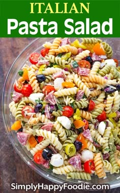 a pasta salad in a glass bowl on top of a wooden table with text overlay