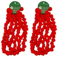 two pairs of red beads hanging from the back of ear clips with green tags on them