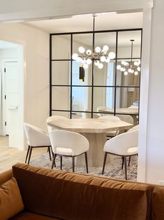 a living room filled with furniture and a large mirror