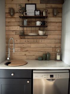 the kitchen is decorated with wood planks and shelving on the wall above the sink