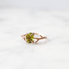 Our dainty Peridot Ring is part of our new Birthstone Ring Collection! This beautiful, yet delicate ring is made with genuine high-quality Peridot. The August Birthstone represents independence + power. Not to mention, the unique look of the whimsical vine ring setting will ensure endless compliments. If you're looking for a ring with style, quality and true meaning, look no further. ---------------------- FEATURES ◊ Oval shaped, brilliant cut faceted genuine Peridot stone (6mm x 8mm) ◊ Choice o Green Peridot Promise Ring, Green Peridot Ring For Promise, Green Peridot Rings With Nature-inspired Style, Nature-inspired Peridot Rings As Gift, Green Promise Rings With Nature-inspired Style, Green Nature-inspired Promise Rings, Nature-inspired Promise Ring With May Birthstone, Nature-inspired May Birthstone Promise Ring, Vine Ring