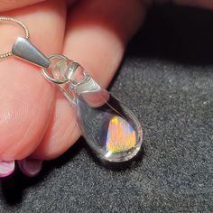 "This opal flashes so many different colors it is hard to capture what it really looks like. My friend Marcy named this style of pendants. She said they look like Mermaid's tears. The teardrop dangle pendant is made by melting borosilicate glass tubing (pyrex) and blowing a bubble at the end of the tube in the flame. The white Gilson opal polished nugget is then placed in the tube and is slowly melted so that the Gilson opal can be completely encased by the borosilicate glass and shaped into a t Handmade Sterling Silver Drop Necklace, Silver Drop Crystal Necklace For Gift, Silver Drop Crystal Necklace Gift, Silver Sterling Silver Teardrop Pendant Crystal Necklace, Silver Teardrop Crystal Necklaces For Gift, Mystical Silver Teardrop Necklace, Silver Opal Drop Jewelry, Silver Teardrop Crystal Necklace Gift, Spiritual Silver Drop Crystal Necklaces