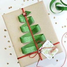 a present wrapped in brown paper with green ribbon