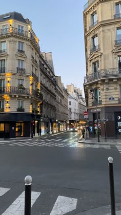 an empty city street with tall buildings on both sides