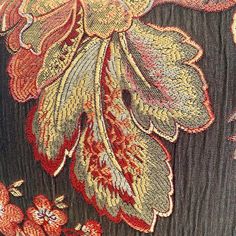 close up view of an embroidered fabric with flowers on it