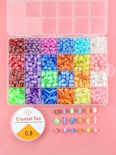 a box filled with lots of different colored beads next to a plastic container full of small objects