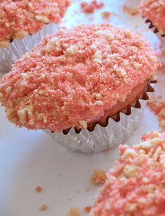 some cupcakes with pink frosting and sprinkles on them