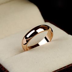 a gold ring sitting on top of a white box