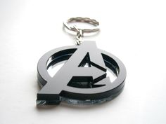 the avengers logo keychain is made out of black and white acrylic