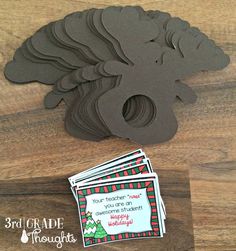 a wooden table topped with lots of cards and a cut out of a horse's head