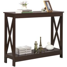 a wooden shelf with some books and other items on it, along with a lamp