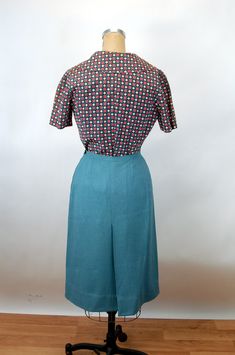 "Beautiful 60s suit, expertly tailored to a Vogue Special Design pattern. Love that cute blouse! And the darling collar on the jacket. The fabric of the jacket and skirt is soft and the color gorgeous! It feels like a fine wool flannel. The blouse has a really sweet collar, is fitted and has covered buttons down the front. They are grouped in sets of three! (one missing). The fabric of the blouse feels like rayon. Love the wide collar! The jacket is lined with the same fabric as the blouse. Note Retro Fitted Skirt Suit, Retro Skirt Suit For Office, Retro Fitted Skirt For Daywear, Fitted Retro Skirt For Daywear, 60s Suit, Blue Skirt Suit, Vintage Runway, Skirt Blouse, Patterned Blouse