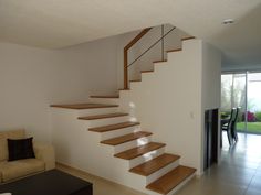 a living room filled with furniture and a stair case