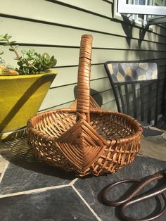 a wicker basket and pair of scissors on the ground