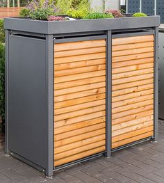 an outdoor storage shed with wooden slats on the sides and plants growing out of it