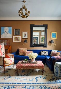 a living room filled with furniture and pictures on the wall