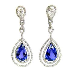 Exquisitely crafted in platinum and diamonds, these double frame tanzanite earrings feature two pear shape diamonds totaling 2.02 carats, pave diamonds totaling 2.57 carats, and two big beautiful tanzanite pear shape stones totaling 14.49 carats. Tanzanite Drop Earrings, Blue Diamond Jewelry, Luxurious Jewelry, Pave Diamond Earrings, Tanzanite Jewelry, Tanzanite Earrings, Double Frame, Diamond Frame, Tanzanite Diamond