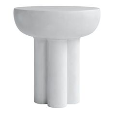 a white pedestal sink with three columns on it