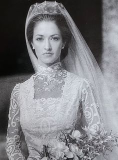 an old black and white photo of a woman in a wedding dress