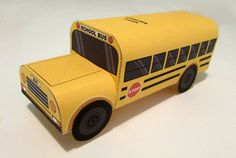 a paper model of a yellow school bus