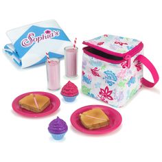 a lunch box, cupcakes and milkshakes are on the table